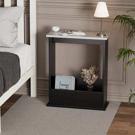 narrow sofa side table in black with silver grey top used as nightstand, lamp and book on top