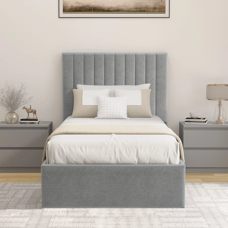 Grey upholstered bed with white bedding in a bedroom setting.