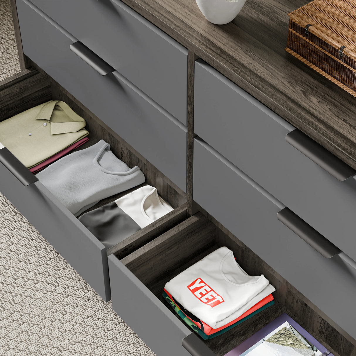 Close-up of bedroom chest of drawers showing two lower drawers opened with a neatly folded stack of clothes