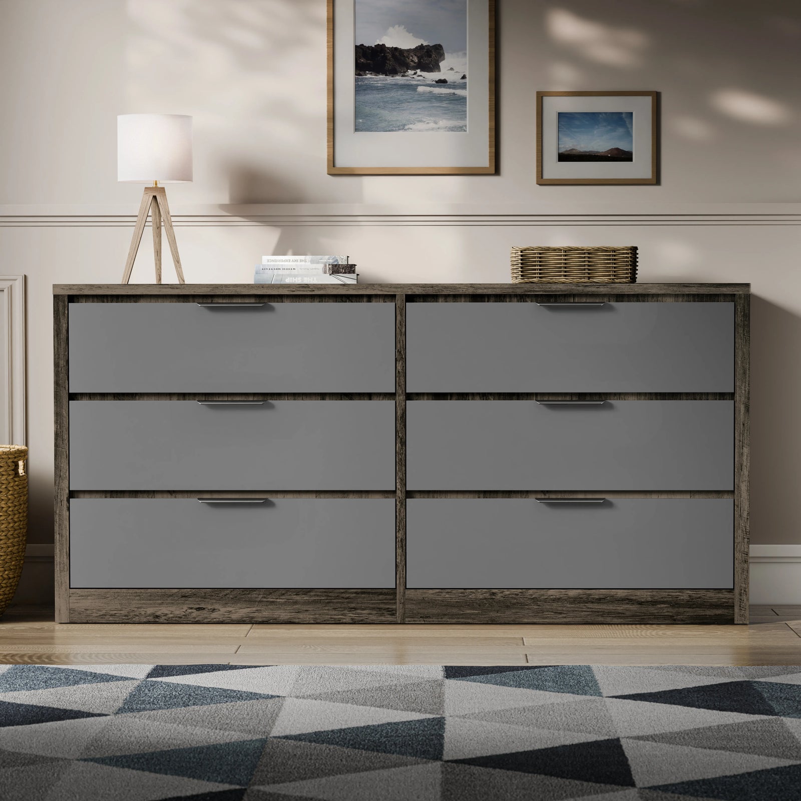Two-tone finish wide chest of drawers placed in a bright room with a patterned rug and lamp