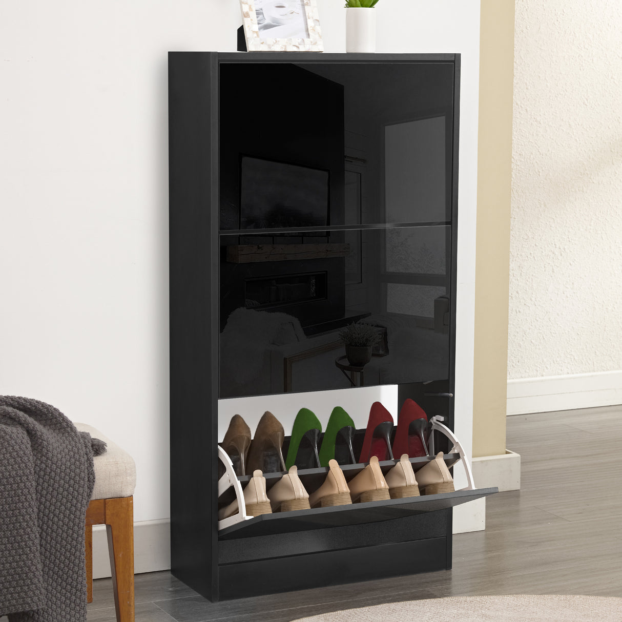 Black gloss shoe cabinet with a high gloss finish, reflecting furniture from a modern living room and 3 tiers.