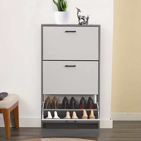 Front view of a narrow shoe cabinet, bottom drawer open to reveal six neatly placed shoes.