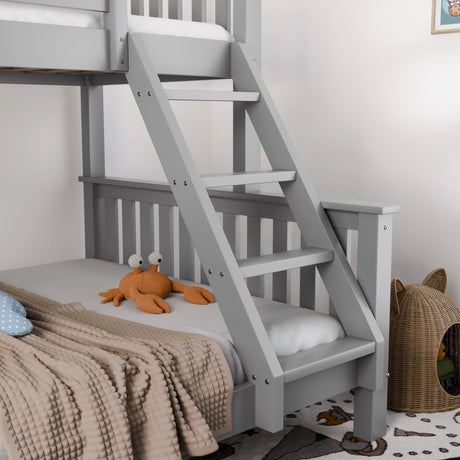 Gray bunk bed with stairs, orange plush toy, and cat tree in a room.
