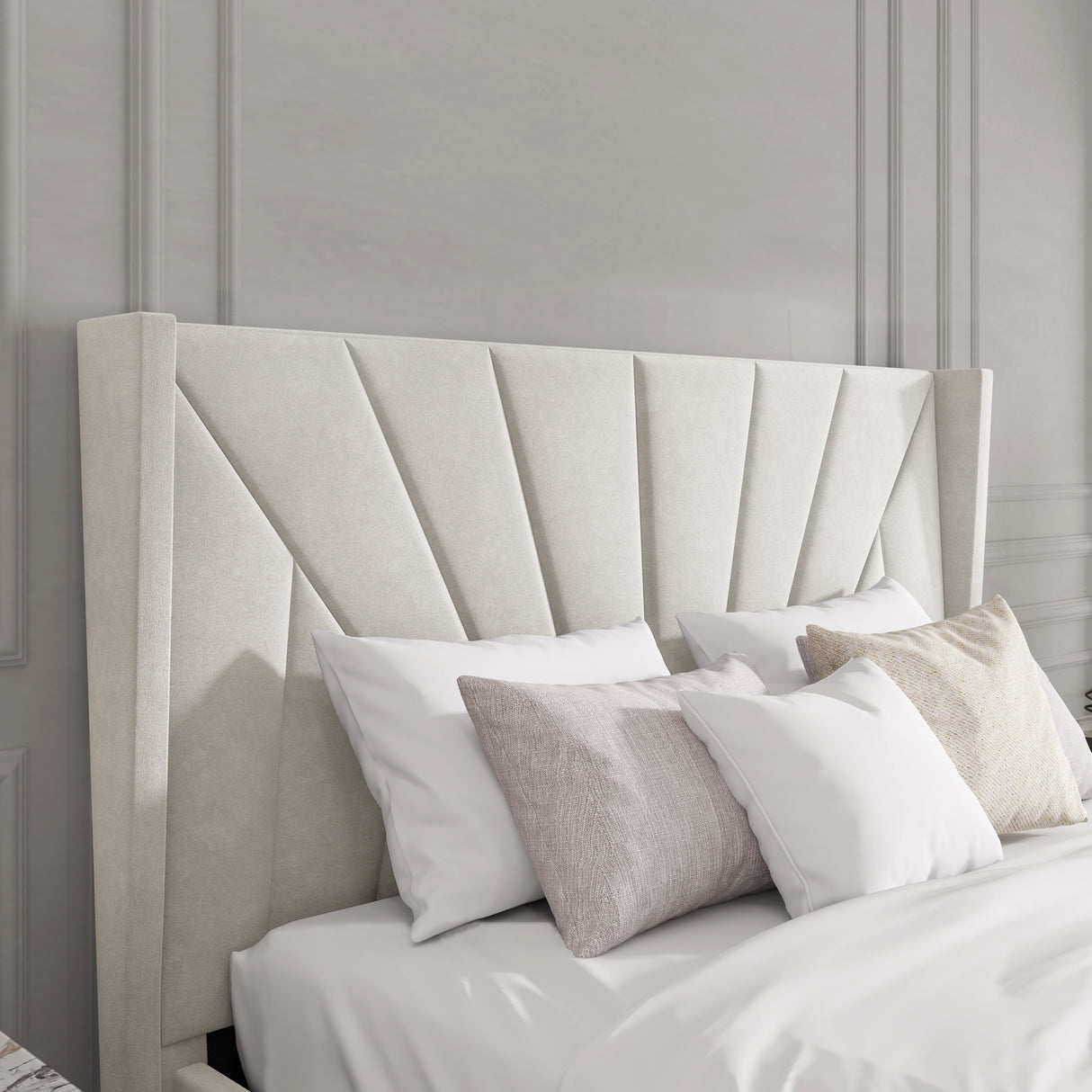 Beige upholstered headboard with decorative pillows against a gray paneled wall.