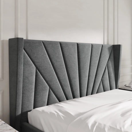 Gray upholstered headboard on a bed with white bedding against a neutral wall.