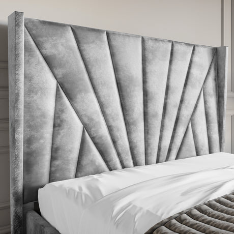 Crushed Velvet Ottoman Storage Bed Silver with Sunrise headboard design. Features plush vertical paneling and luxurious silver upholstery.