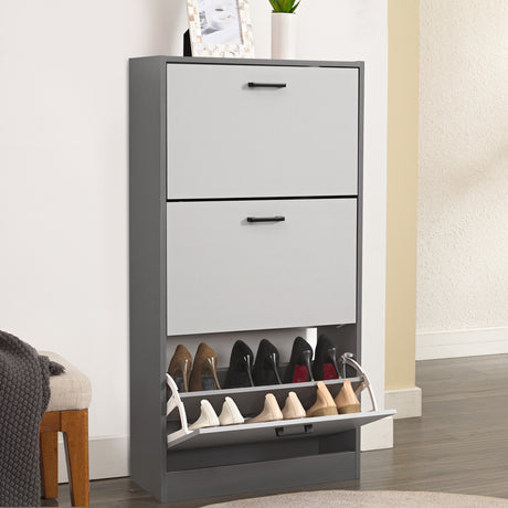 Two tone grey shoe cabinet styled as a 3 tier shoe cabinet, with shoes in the bottom drawer and decor on top.