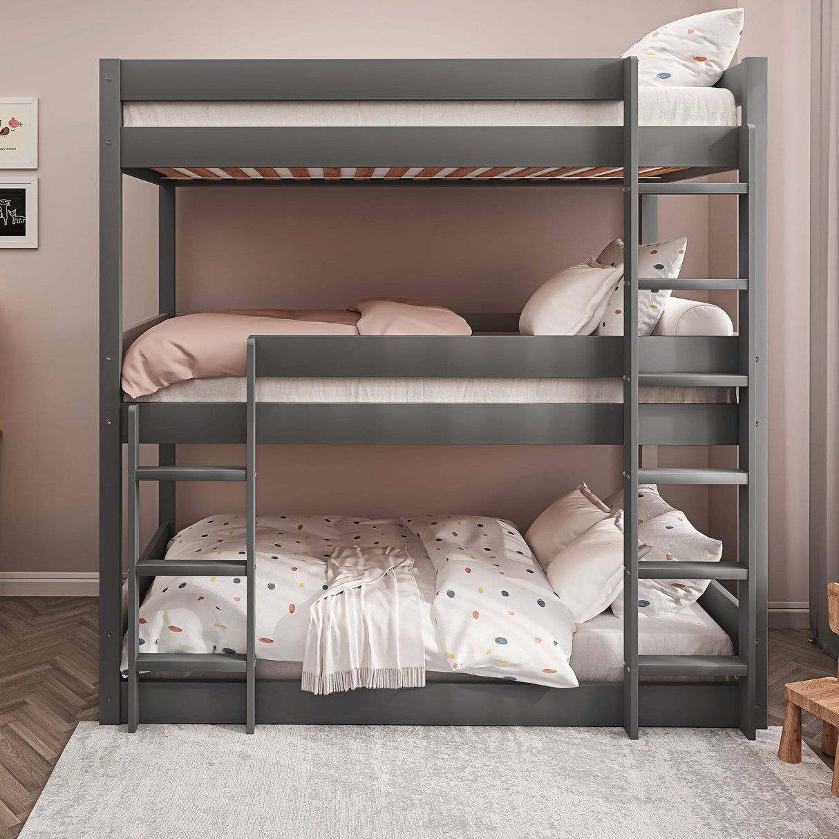 Front view of grey single triple bunk bed with polka dot bedding. Wooden high sleeper frame ideal for shared kids' bedrooms.
