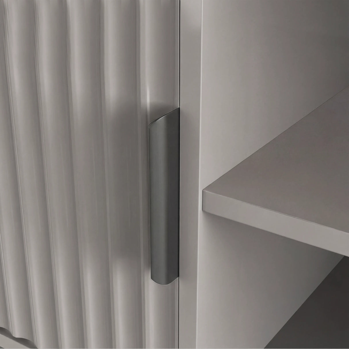 Front view of a grey TV entertainment unit with textured vertical slats, open shelving, and grey handle.