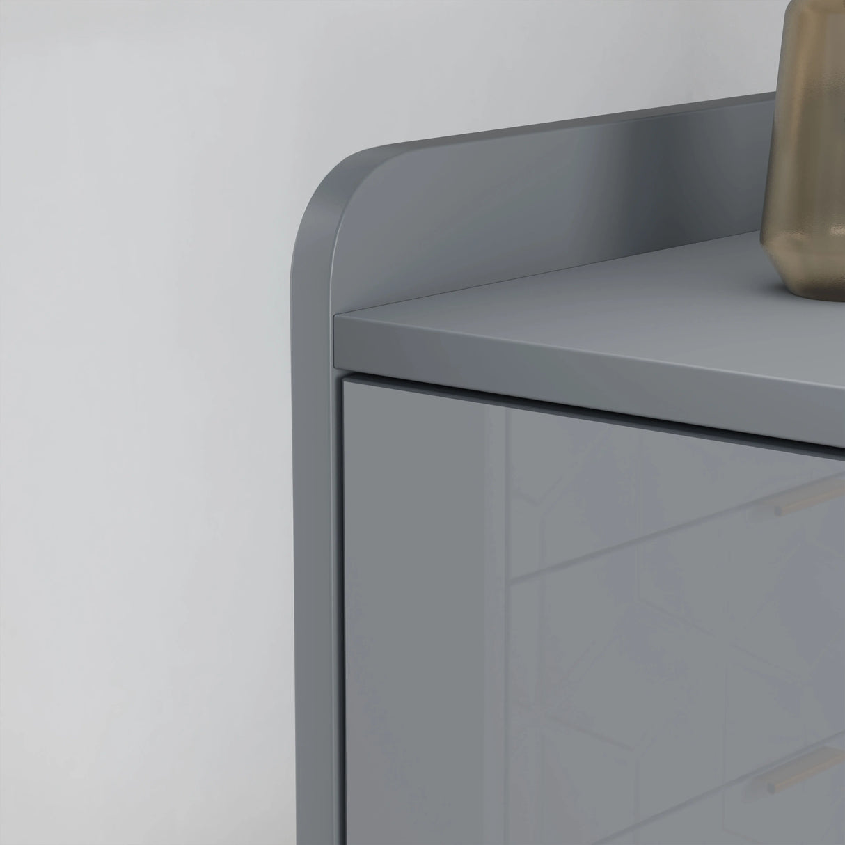 Gray side table with a curved design against a white wall