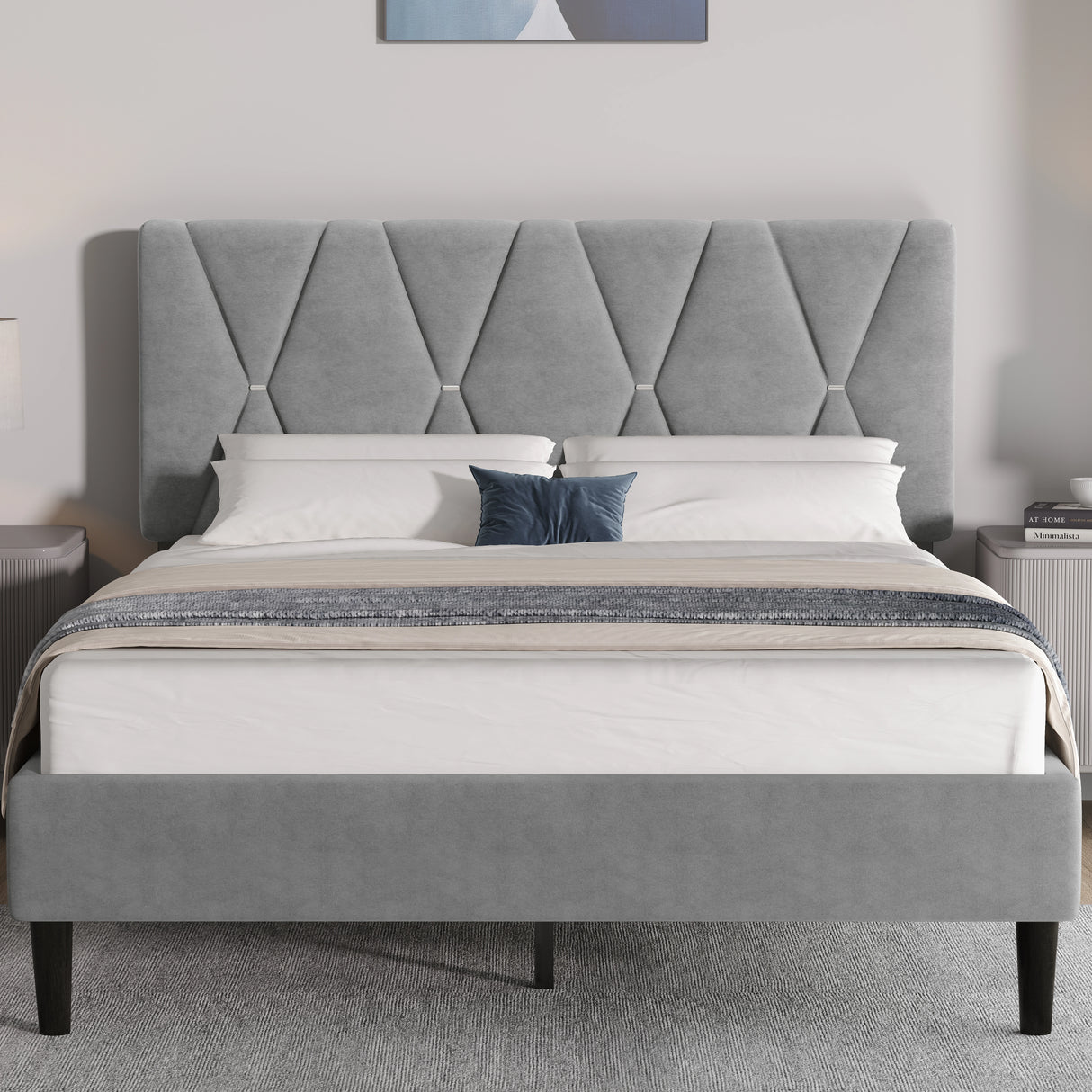 Grey upholstered bed with tufted headboard in a bedroom setting