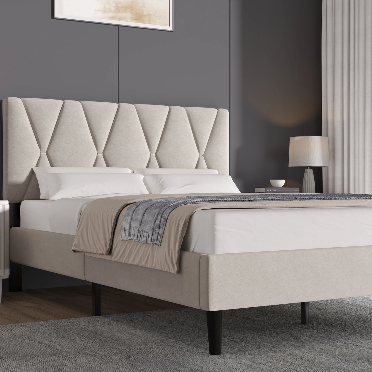 Beige upholstered bed with tufted headboard in a bedroom setting.