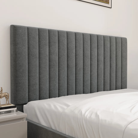 Gray upholstered headboard with white bedding in a bedroom setting