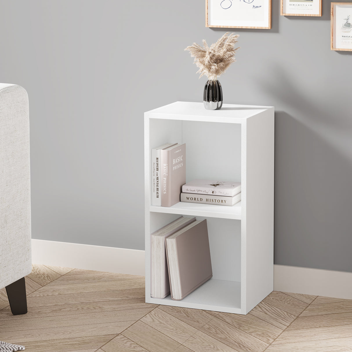 angled front view of white 2 shelf bookcase styled with decor and books, great for small corners in modern living spaces