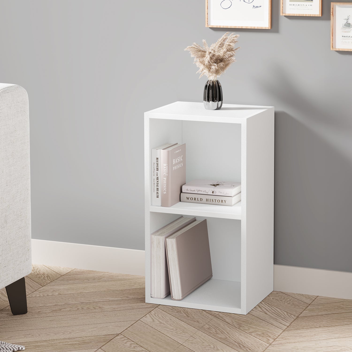 angled front view of white 2 shelf bookcase styled with decor and books, great for small corners in modern living spaces