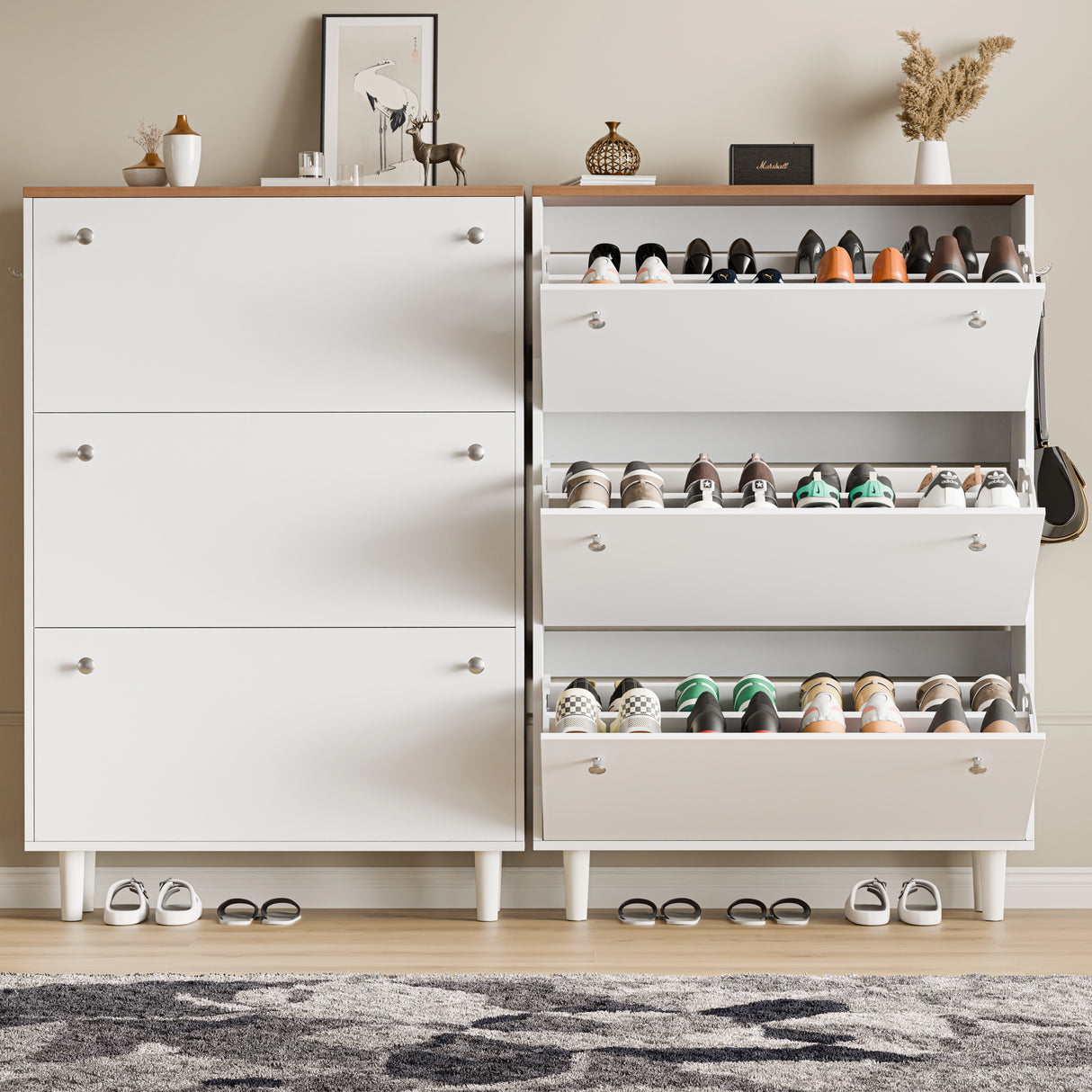 Two slim shoe cabinet units in white oak top, one drawer open showing shoes and wellies, bag on hook, decor placed on top.