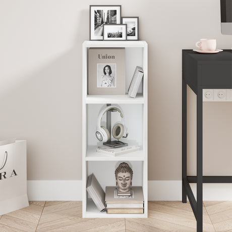 front view of white slim bookcase showcasing neat shelves with books and art pieces for modern spaces
