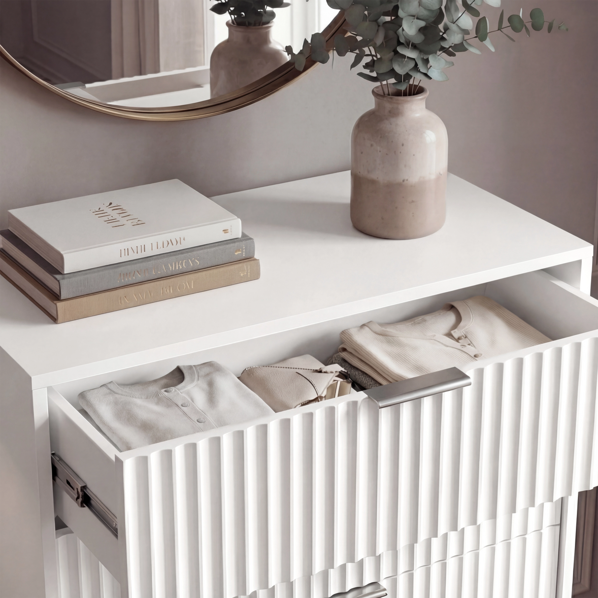 Close detail of white flutrina drawer front with silver metal handle and vertical textured panel design