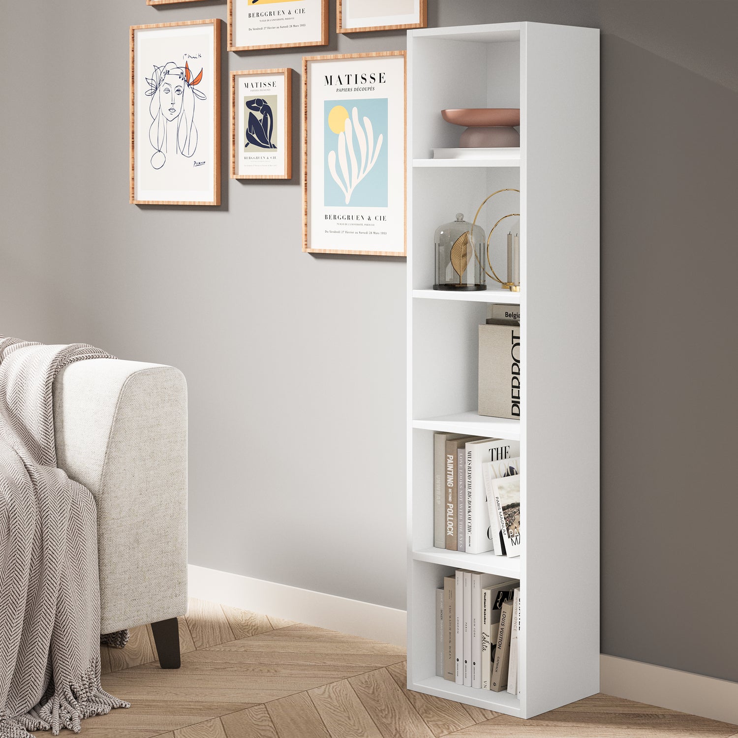 angled front view of 5 tier white narrow bookshelf styled with books and decor for modern living spaces