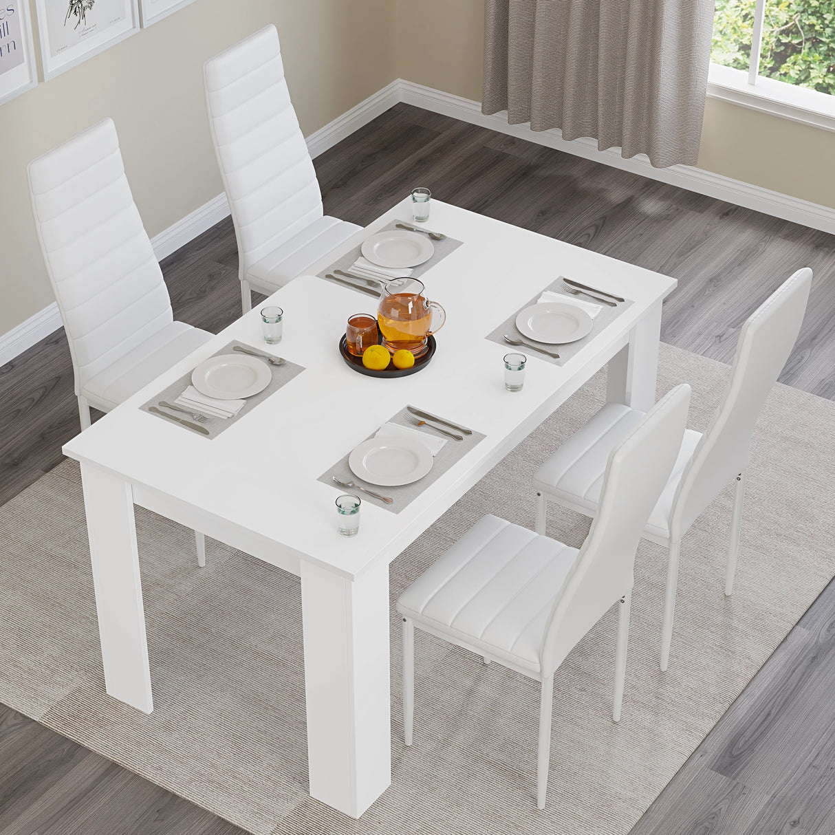 Top view of white dining table set with white PU leather chairs for 4. Perfect for minimalist kitchen or dining areas.