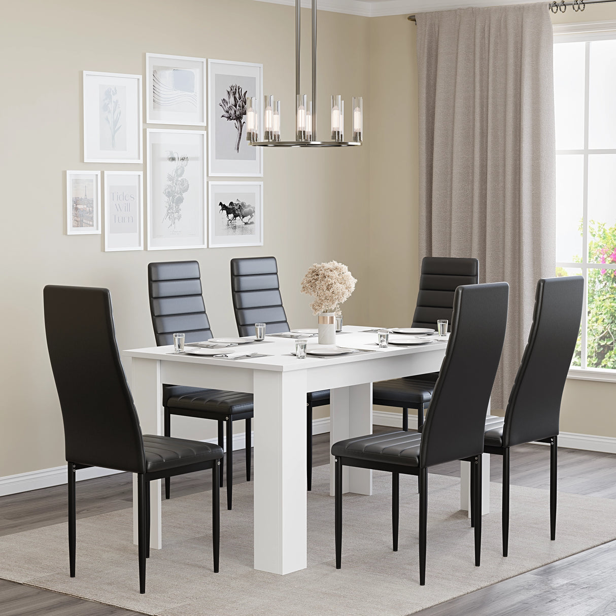 White dining table set for 6 with black leather chairs, styled in a modern dining room with wall art and chandelier. Spacious and elegant.