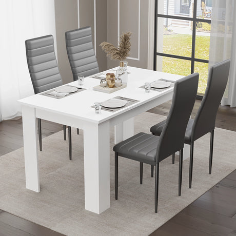 Sleek side view of a white dining table with black chairs, set for four — a refined choice for modern dining or kitchen spaces