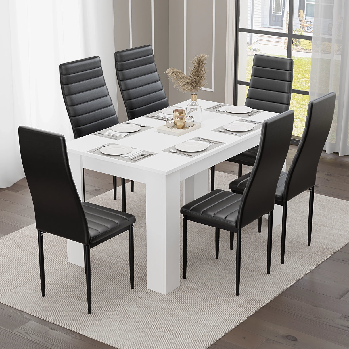 Clean white table with seating for six and sleek black leather chairs, set in a refined modern space.