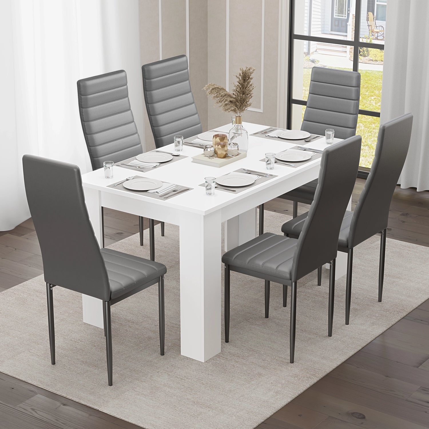 Modern white dining table paired with six grey chairs, creating a stylish and functional space for family dining."