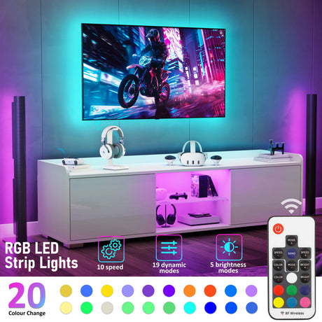 White entertainment console with RGB LED strip lights, TV, and speakers in a room.