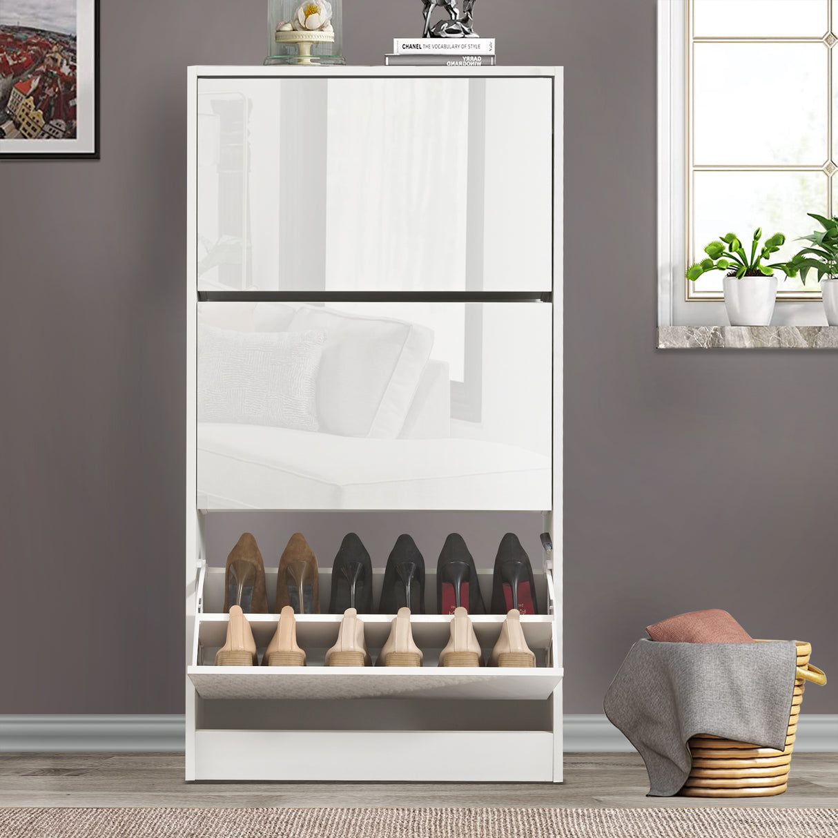 Front view of shoe cabinet in hallway with the lowest drawer open, showing multiple pairs of shoes neatly arranged.