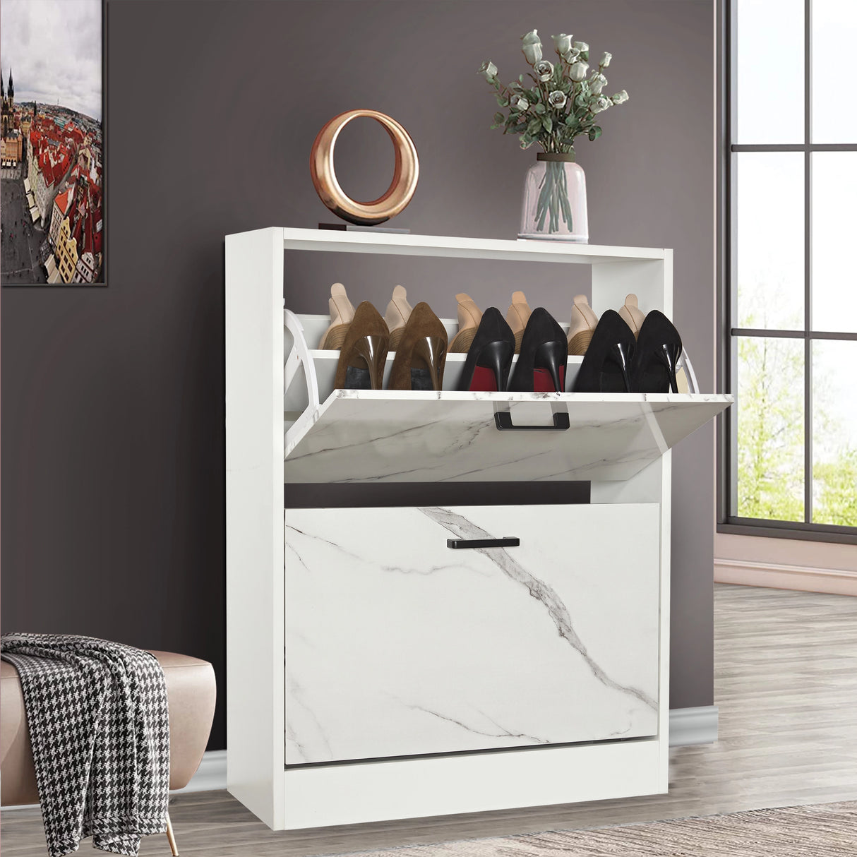 Slim shoe cabinet for hallway in white marble finish with pull-down drawer open and decorative accents placed on top.