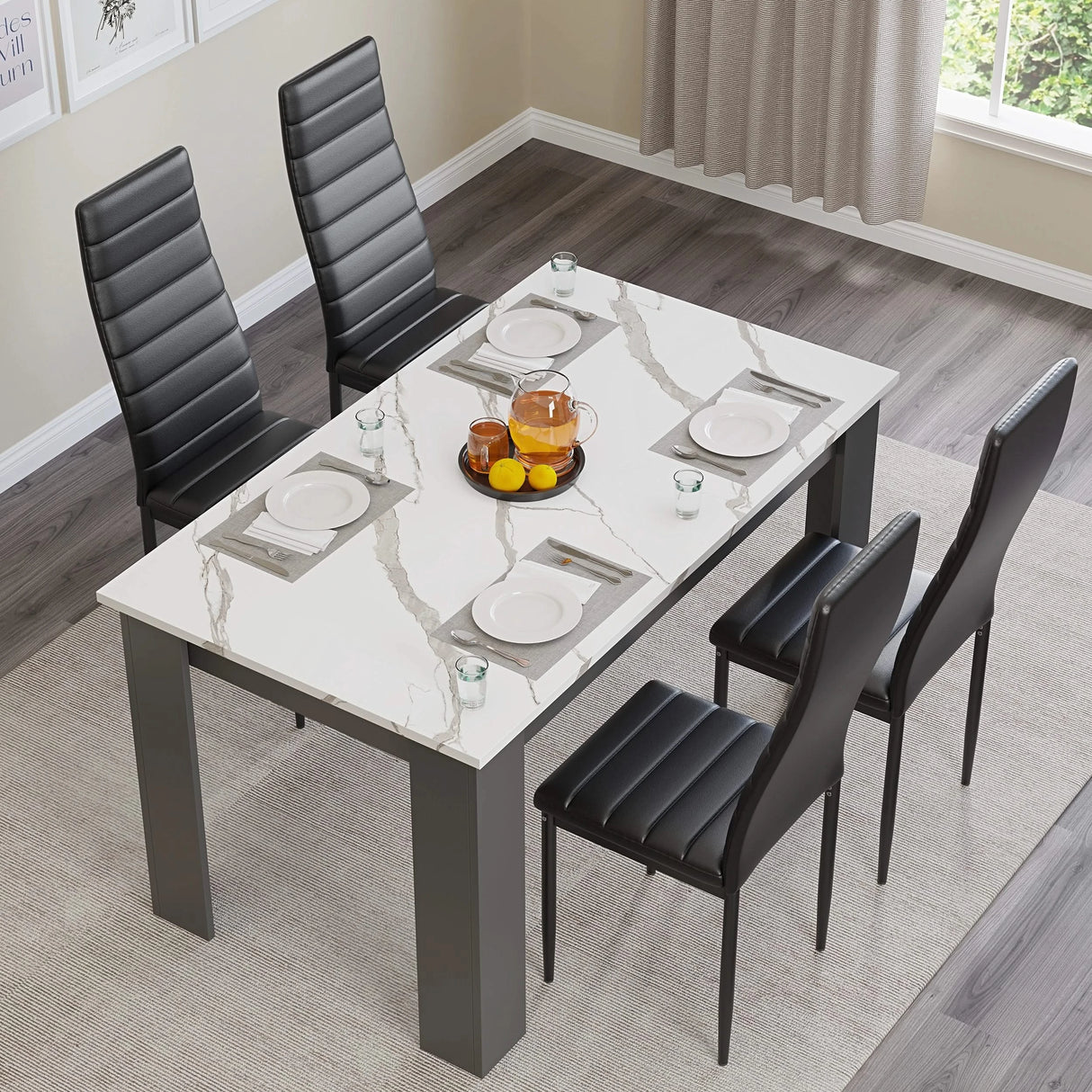 top-down view of white marble kitchen table and chairs upholstered in black PU arranged with plates in dining space