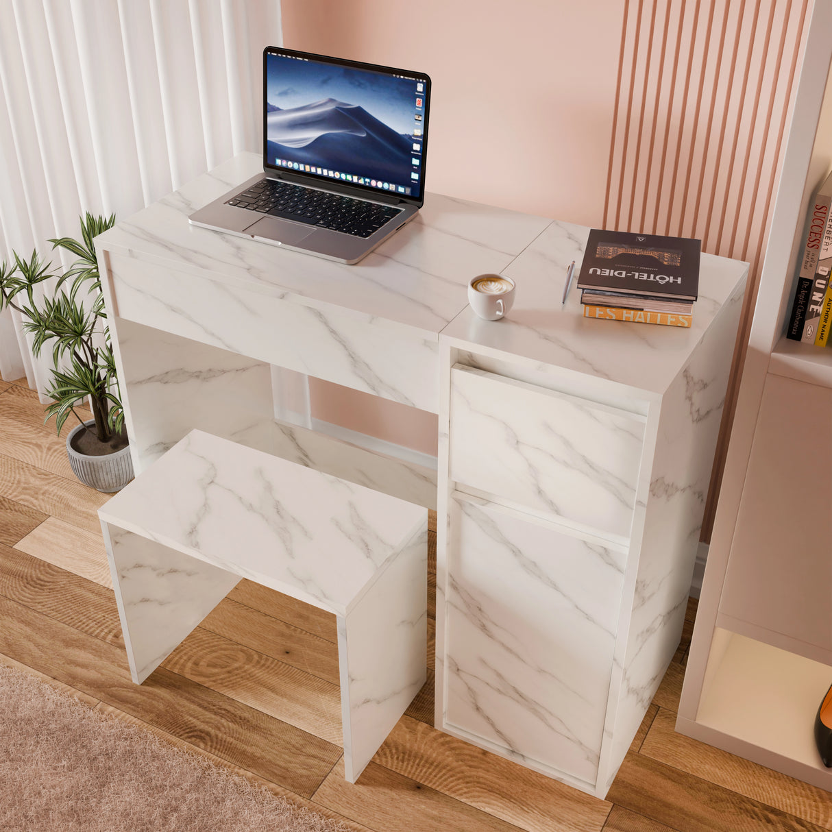 Marble-patterned desk with a laptop, books, and a cup on a wooden floor.