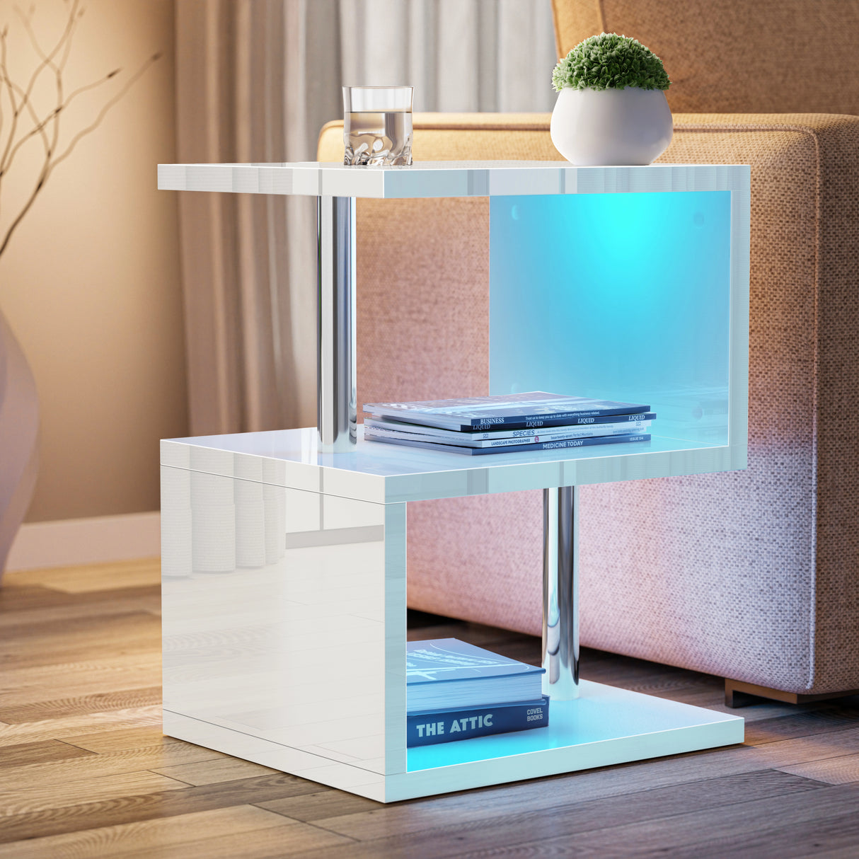 Modern side table with a glass top displaying books and a plant, placed in a living room setting.