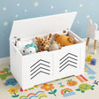 White toy box with stuffed animals on a colorful rug with star-patterned wall