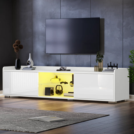 Modern white entertainment console with yellow interior lighting in a living room setting.