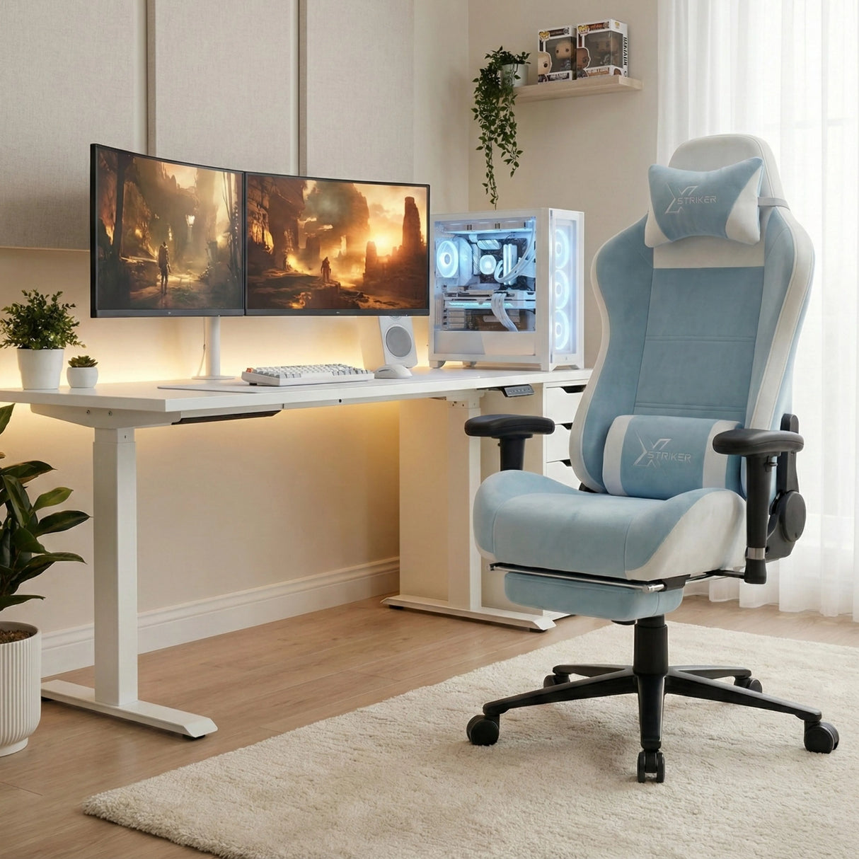 Xstriker Velvet Gaming Chair with Footrest in light blue and white, placed in a modern gaming setup with dual monitors and a white PC case.