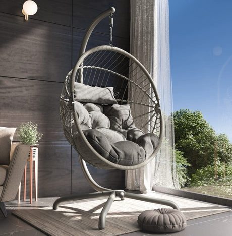 A hanging egg chair by the window in a home.