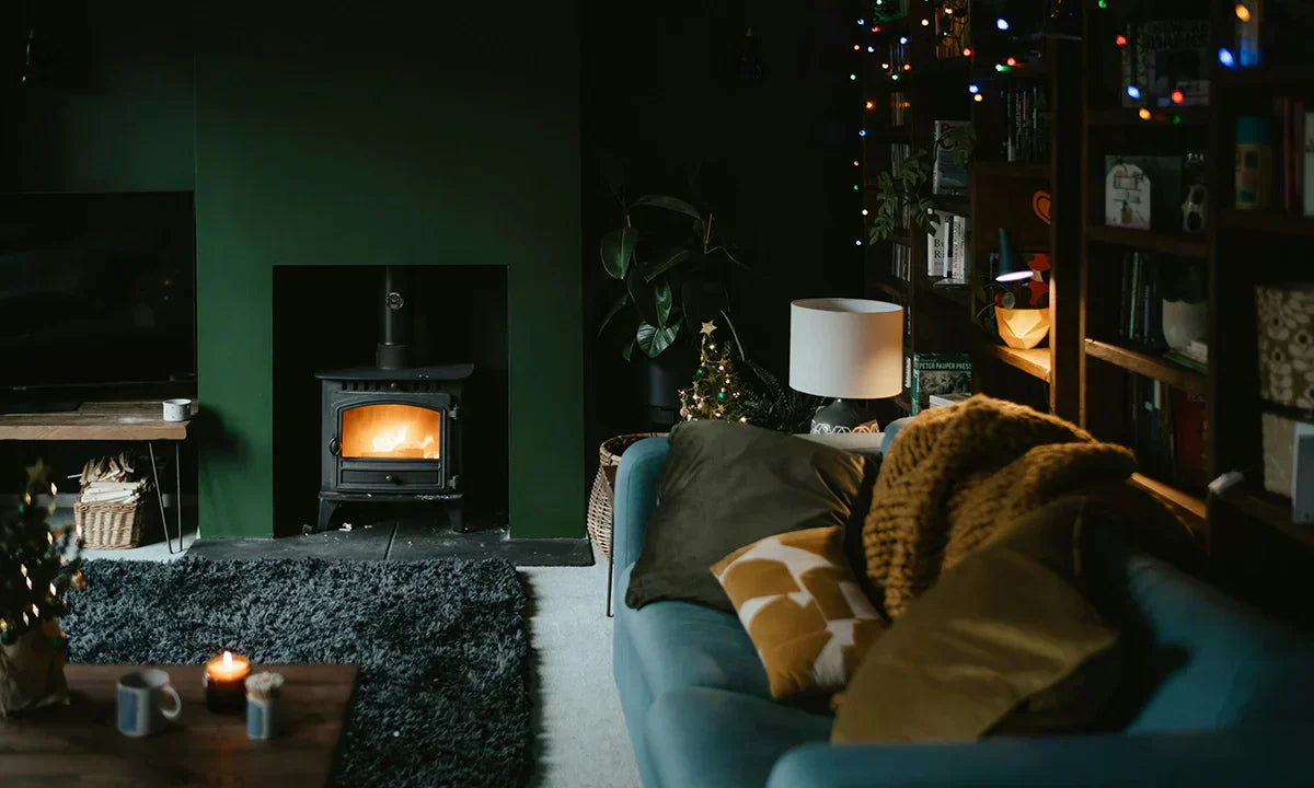 Cosy living room with warm ambience and dark walls.
