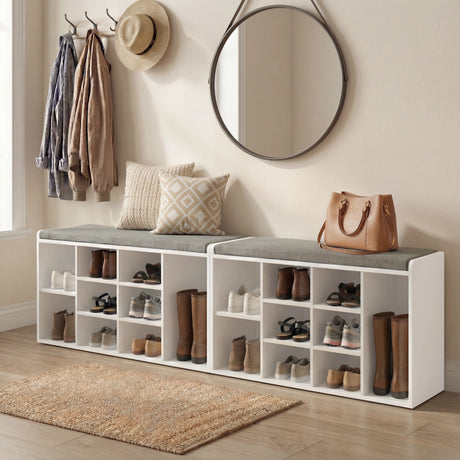 Shoe storage bench with cushion in white featuring multiple cubbies for footwear, ideal for hallway organization and entryway seating.