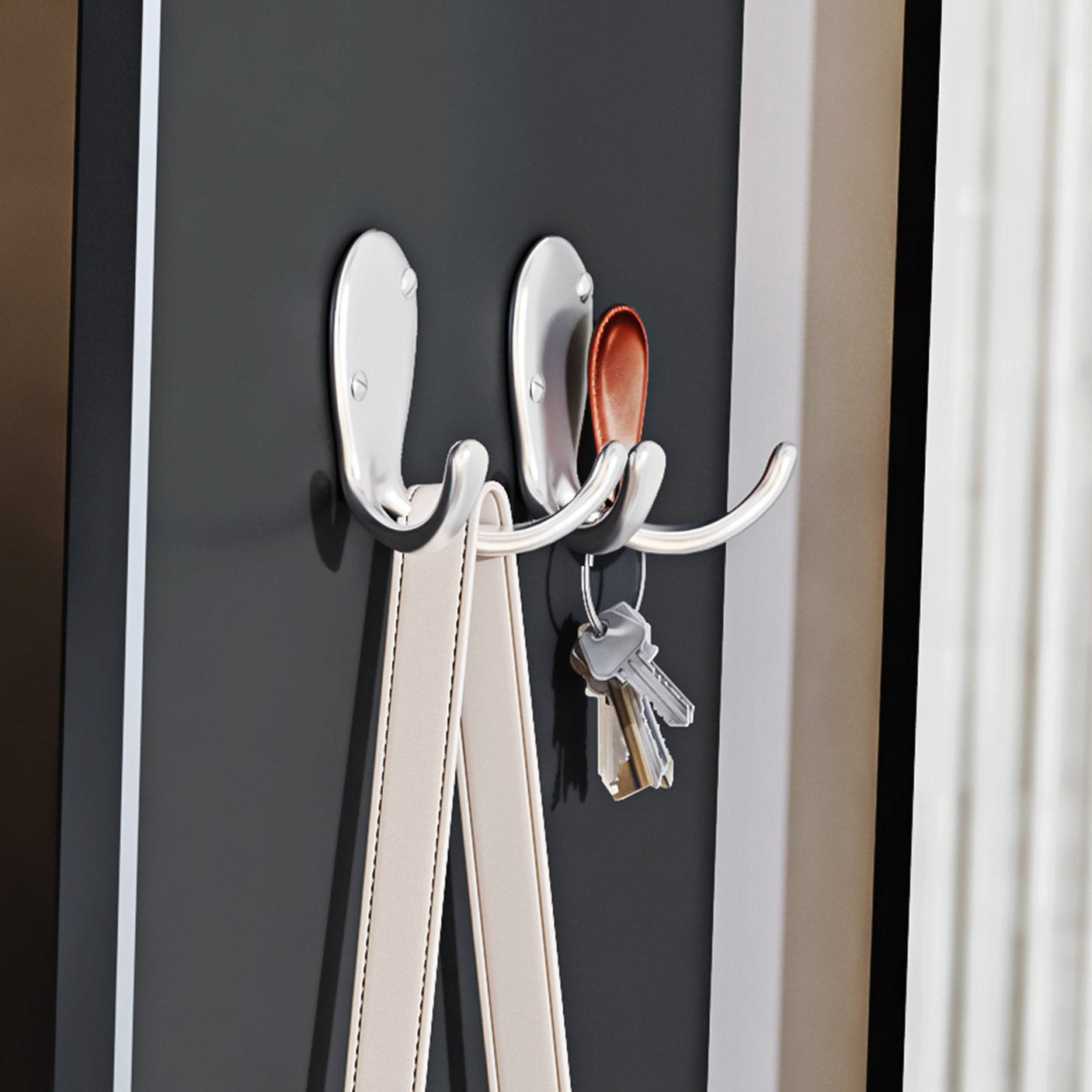Close-up of chrome hooks on black Blisswood Shoe Cabinet Hallway for hanging keys and accessories. Functional hallway organizer.