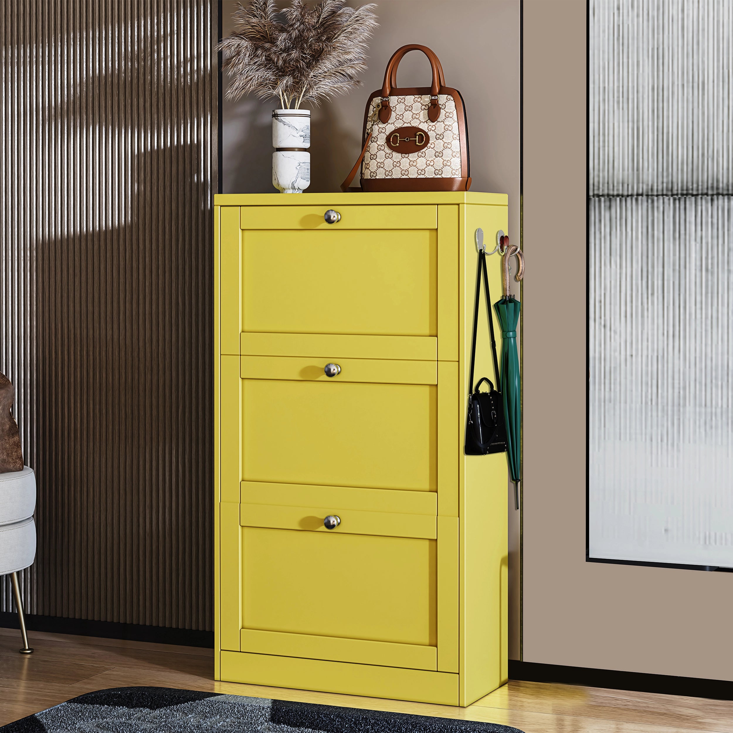 Modern Slim Shoe Cabinet in Yellow Finish with Space-Saving Design Bright yellow shoe cabinet with three flip-down drawers, decorated with a handbag and vase, placed in a modern entryway.