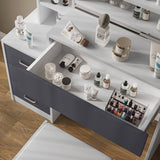 Close-up of white vanity table with grey drawer open. Organized storage for cosmetics and nail polish in a modern bedroom setup.