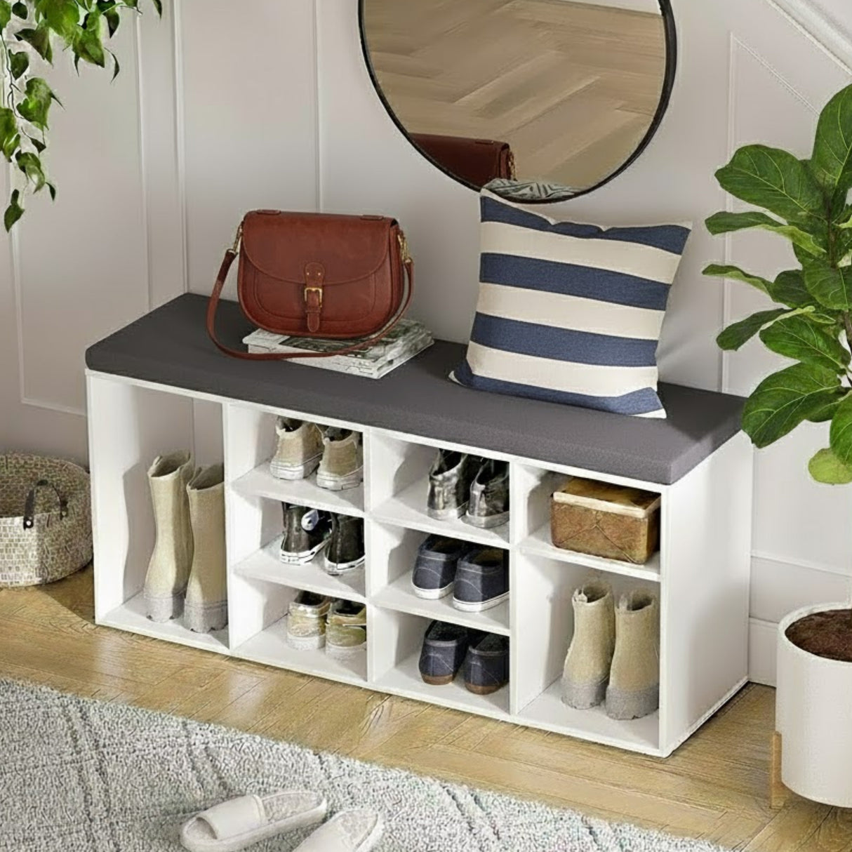 White shoe storage bench with shelves, a round mirror, and decorative items in a room.