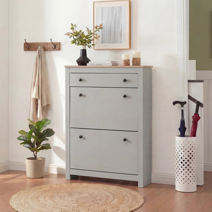 [Grey] Shoe cabinet with all compartments shut styled in hallway with plant and umbrella stand