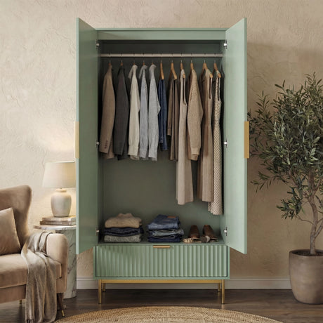 Green flutrina double wardrobe with hanging space and a bottom drawer, placed against a wall on a wooden floor