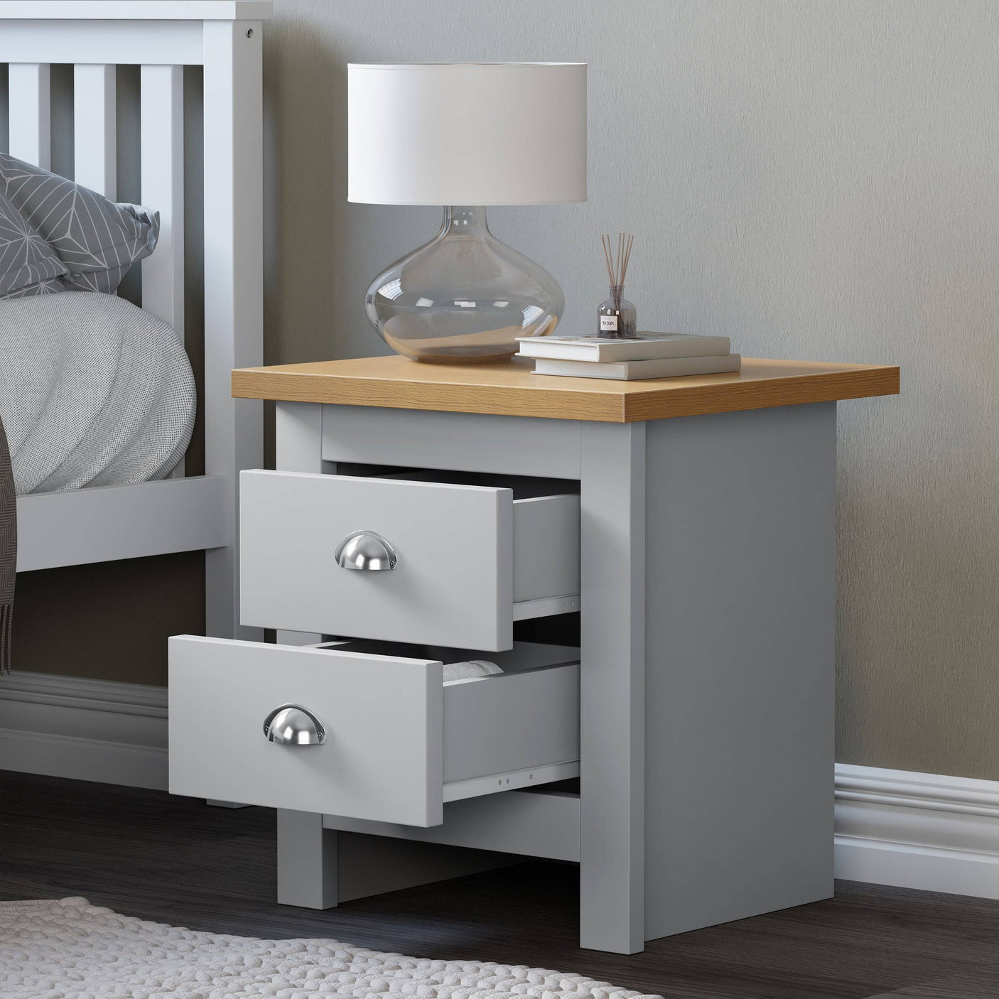 2 drawer bedside table UK, open drawer design with books on top for a stylish bedroom look.