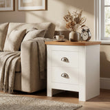 [White]  White nightstand with wooden top next to a beige sofa in a cozy living room.