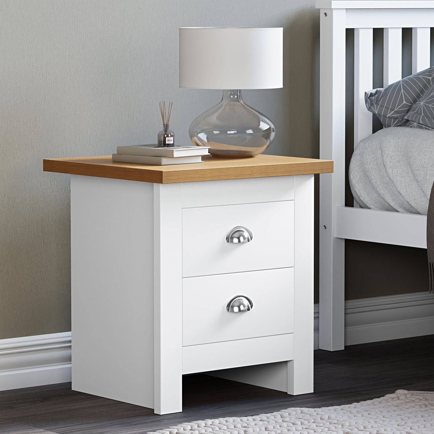 2 drawer white bedside table with top surface for books and lamp, stylish and functional.