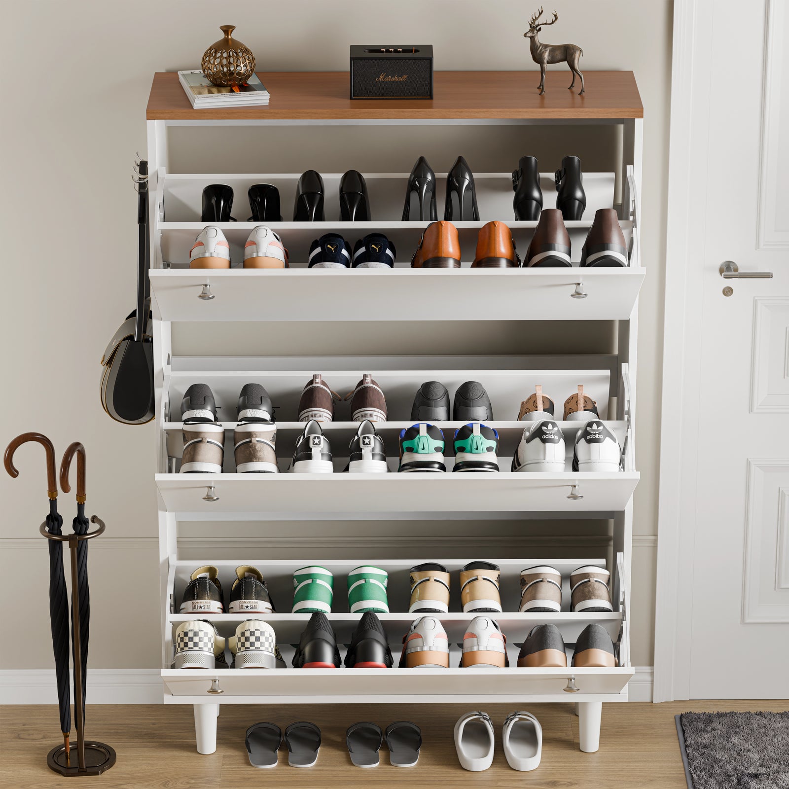 [White] Open shoe cabinet, every tilt door dropped to reveal pairs of shoes held on angled interior racks
